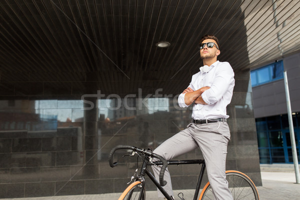 man with bicycle and headphones on city street Stock photo © dolgachov