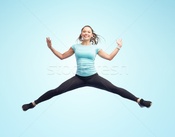 ストックフォト: 幸せ · 笑みを浮かべて · スポーティー · 若い女性 · ジャンプ · 空気