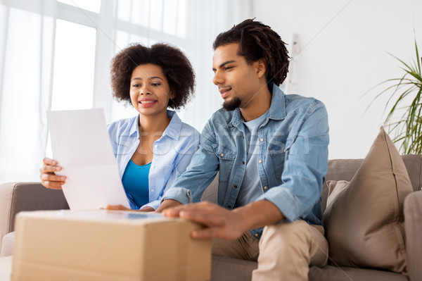 happy couple with parcel box and paper form home Stock photo © dolgachov