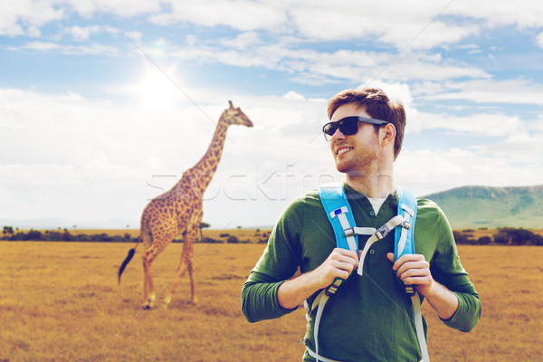 happy man with backpack traveling in africa Stock photo © dolgachov