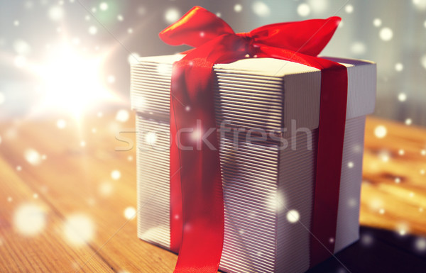 close up of christmas gift box on wooden table Stock photo © dolgachov