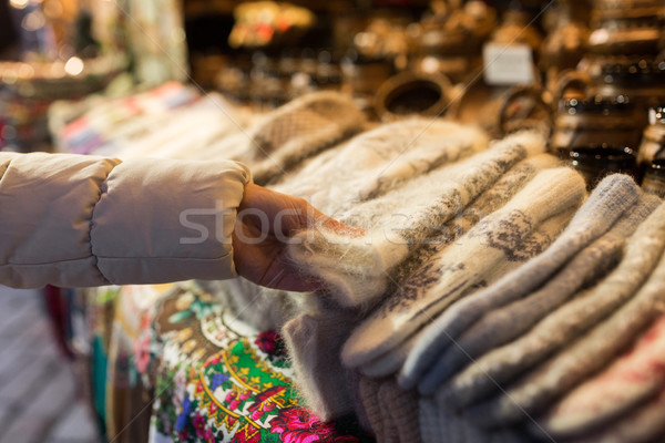 woman buying woolen mittens at christmas market Stock photo © dolgachov