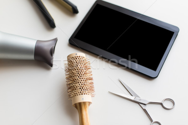 tablet pc, scissors, hairdryer, hot iron and brush Stock photo © dolgachov