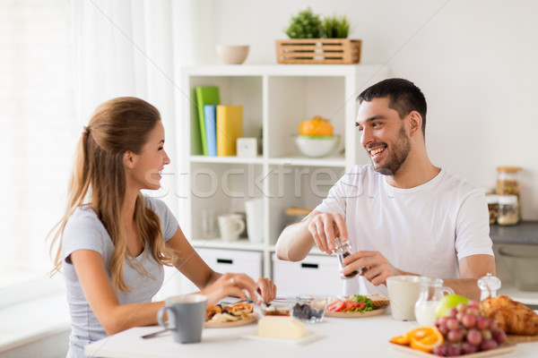 happy couple having breakfast at home Stock photo © dolgachov