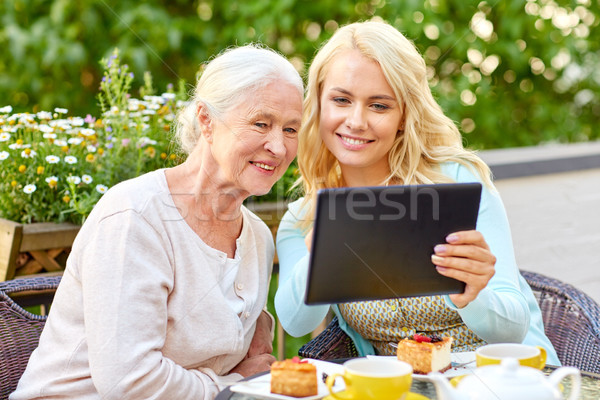 daughter with tablet pc and senior mother at cafe Stock photo © dolgachov