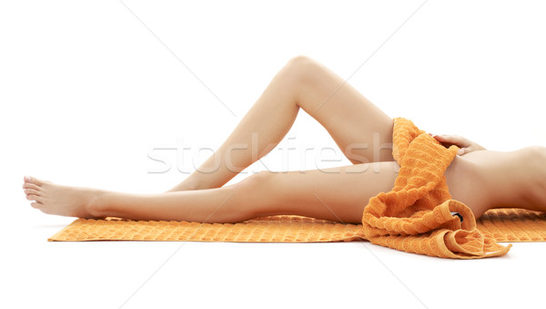Długie nogi pani pomarańczowy ręcznik biały Zdjęcia stock © dolgachov