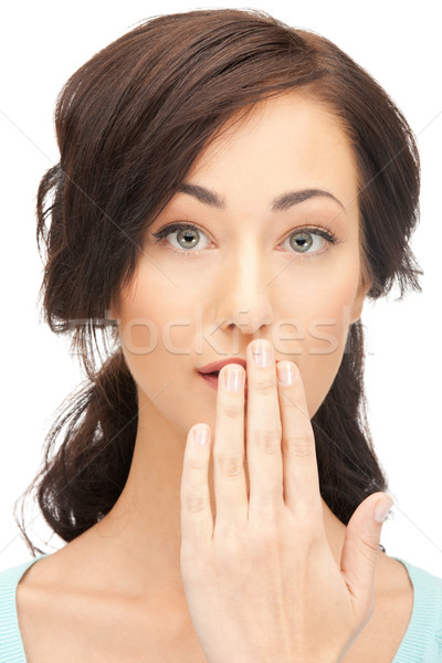 woman with hand over mouth Stock photo © dolgachov