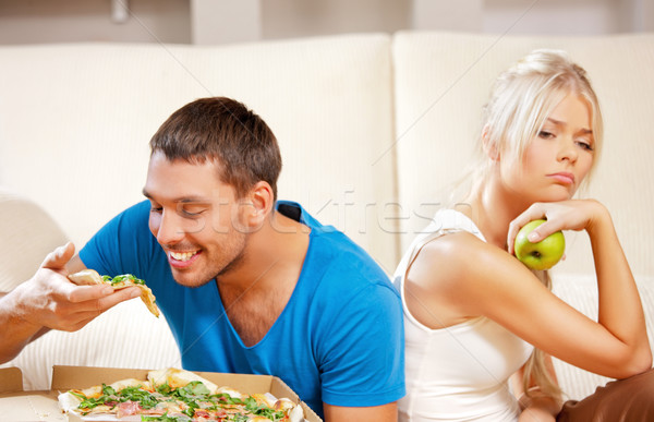 couple eating different food Stock photo © dolgachov
