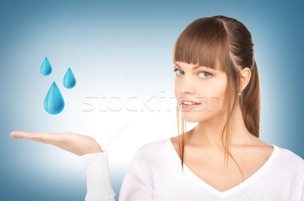 Nő mutat kék vízcseppek kéz női Stock fotó © dolgachov