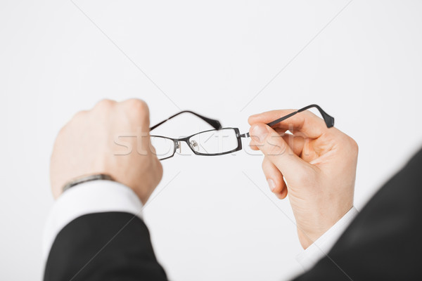 man hands holding eyeglasses Stock photo © dolgachov