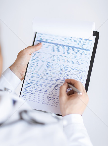 male doctor holding prescription paper in hand Stock photo © dolgachov
