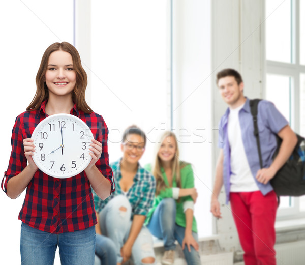 young woman in casual clothes with wall clock Stock photo © dolgachov