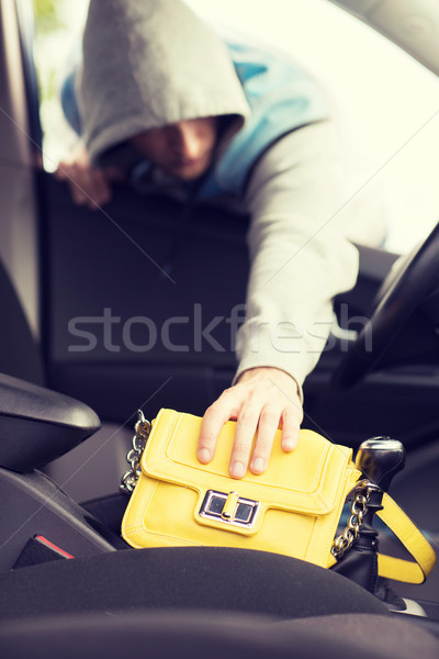 thief stealing bag from the car Stock photo © dolgachov