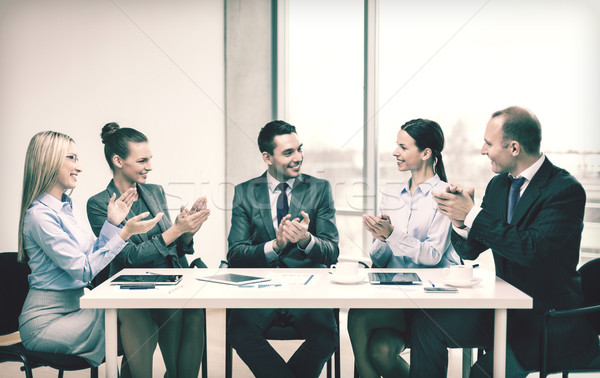 business team with laptop clapping hands Stock photo © dolgachov