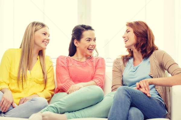 three girlfriends having a talk at home Stock photo © dolgachov