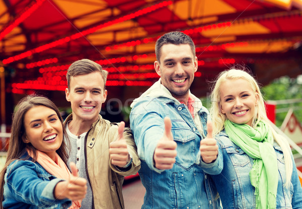 group of smiling friends showing thumbs up Stock photo © dolgachov
