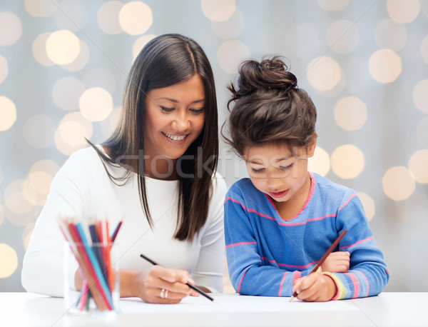 happy mother and daughter drawing with pencils Stock photo © dolgachov