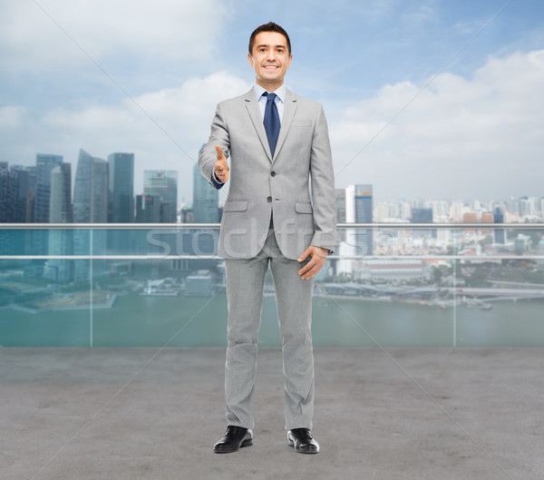 happy smiling businessman in suit shaking hand Stock photo © dolgachov