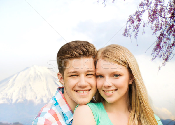 smiling couple hugging over mountains background Stock photo © dolgachov