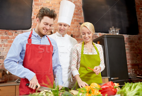 happy couple and male chef cook cooking in kitchen Stock photo © dolgachov