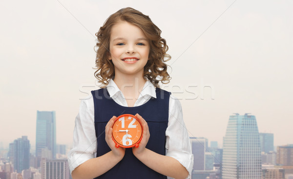 happy girl with alarm clock over city background Stock photo © dolgachov
