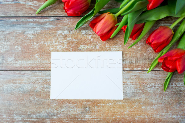 Stock photo: close up of red tulips and blank paper or letter