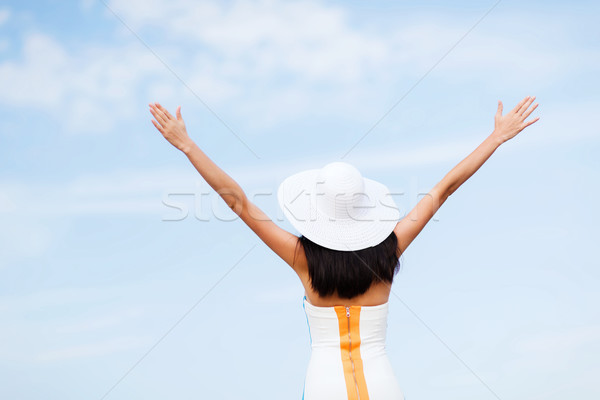 girl with hands up on the beach Stock photo © dolgachov