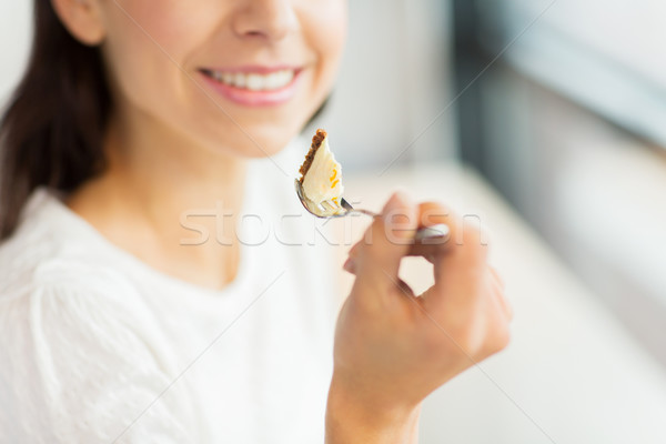 close up of woman eating cake at cafe or home Stock photo © dolgachov