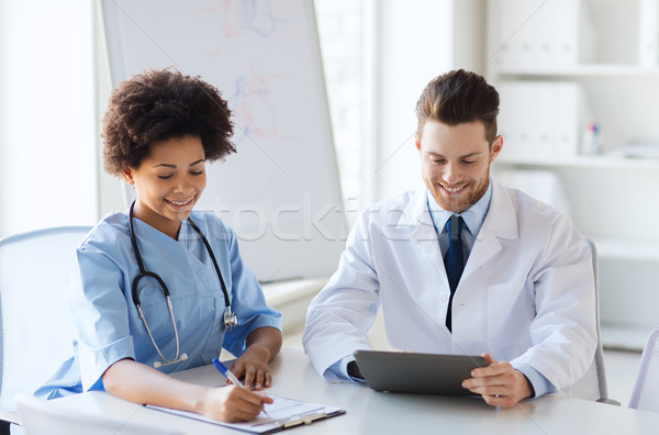 two happy doctors meeting at hospital office Stock photo © dolgachov