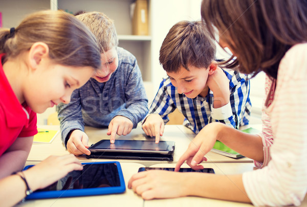 group of school kids with tablet pc in classroom Stock photo © dolgachov