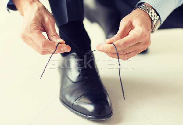 close up of man leg and hands tying shoe laces Stock photo © dolgachov