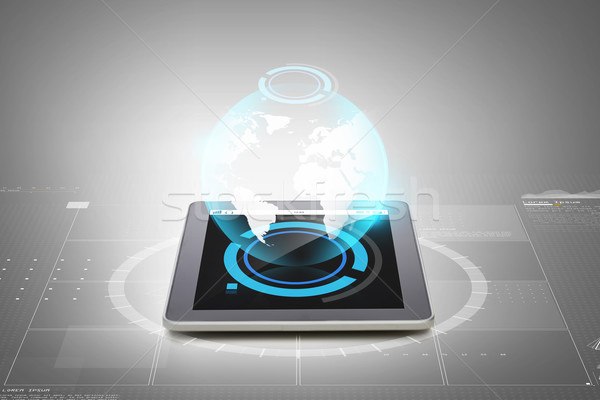 close up of tablet pc with earth globe hologram Stock photo © dolgachov