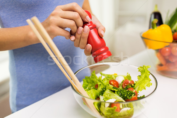 close up of woman cooking vegetable salad at home Stock photo © dolgachov