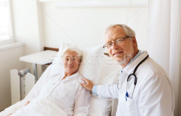 doctor visiting senior woman at hospital ward Stock photo © dolgachov
