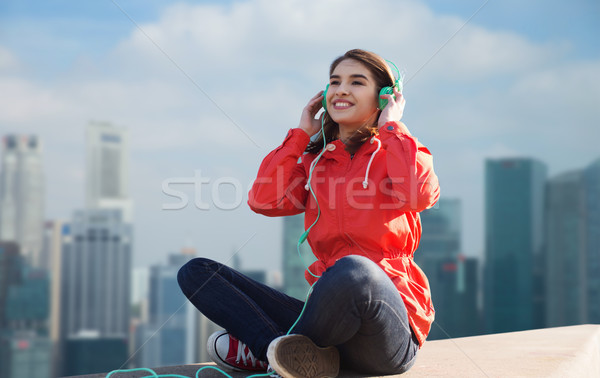happy young woman in headphones listening to music Stock photo © dolgachov