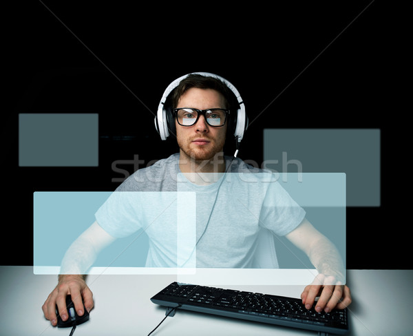 man in headset playing computer video game Stock photo © dolgachov