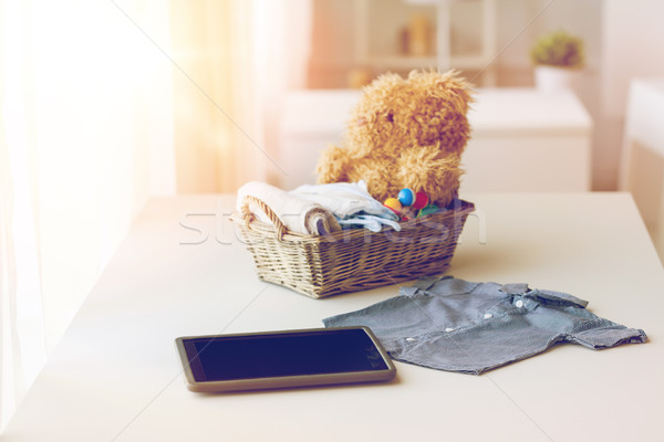 close up of baby clothes, toys and tablet pc Stock photo © dolgachov