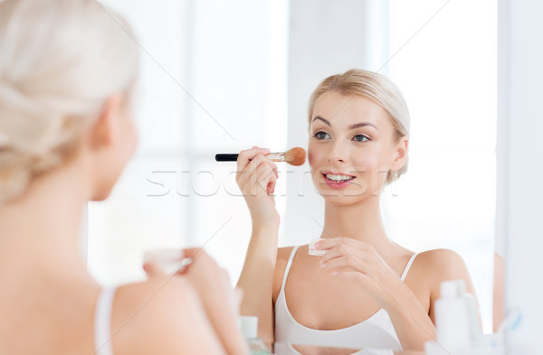 woman with makeup brush and powder at bathroom Stock photo © dolgachov