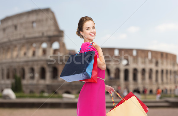 happy woman with shopping bags over coliseum Stock photo © dolgachov