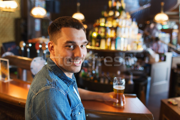 happy man drinking beer at bar or pub Stock photo © dolgachov