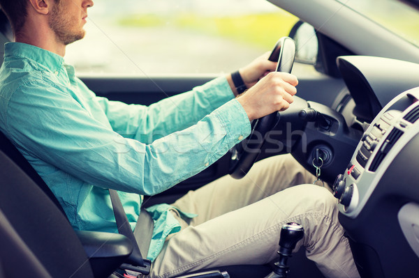 close up of young man driving car Stock photo © dolgachov