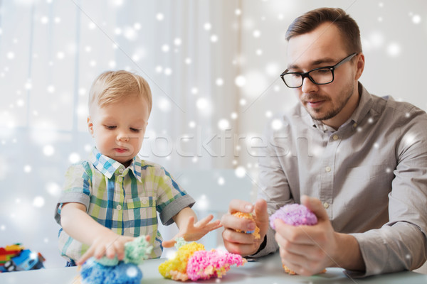 father and son playing with ball clay at home Stock photo © dolgachov