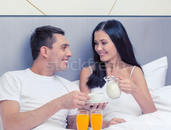 smiling couple having breakfast in bed in hotel Stock photo © dolgachov