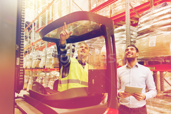 Stock photo: men with tablet pc and forklift at warehouse