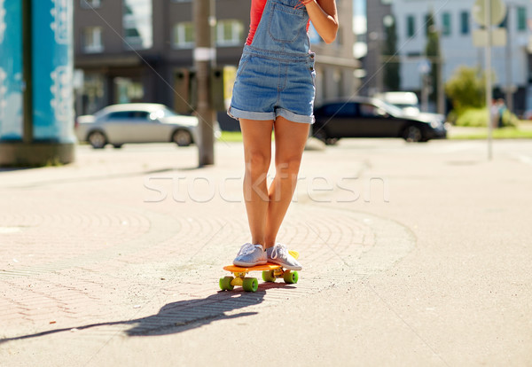 teenage girl riding skateboard on city street Stock photo © dolgachov