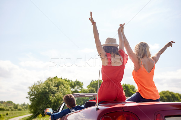 happy friends driving in cabriolet car at country Stock photo © dolgachov