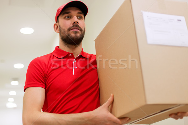 delivery man with parcel box in corridor Stock photo © dolgachov