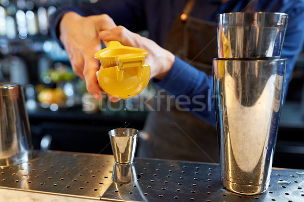 bartender squeezing juice into jigger at bar Stock photo © dolgachov