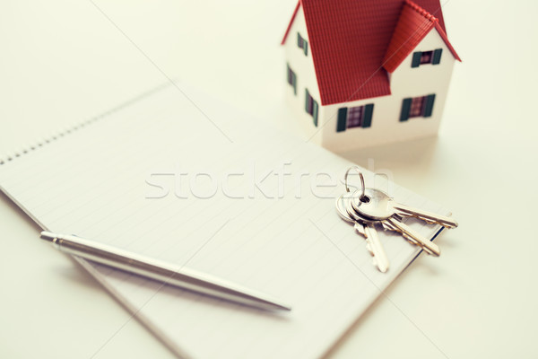 close up of home model, house keys and notebook Stock photo © dolgachov