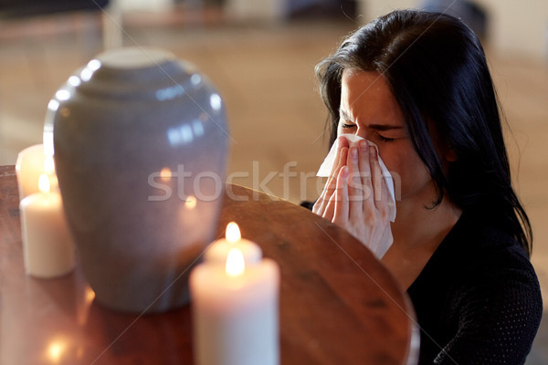woman with cremation urn at funeral in church Stock photo © dolgachov